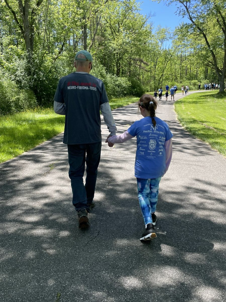 Man and child holding hands while walking