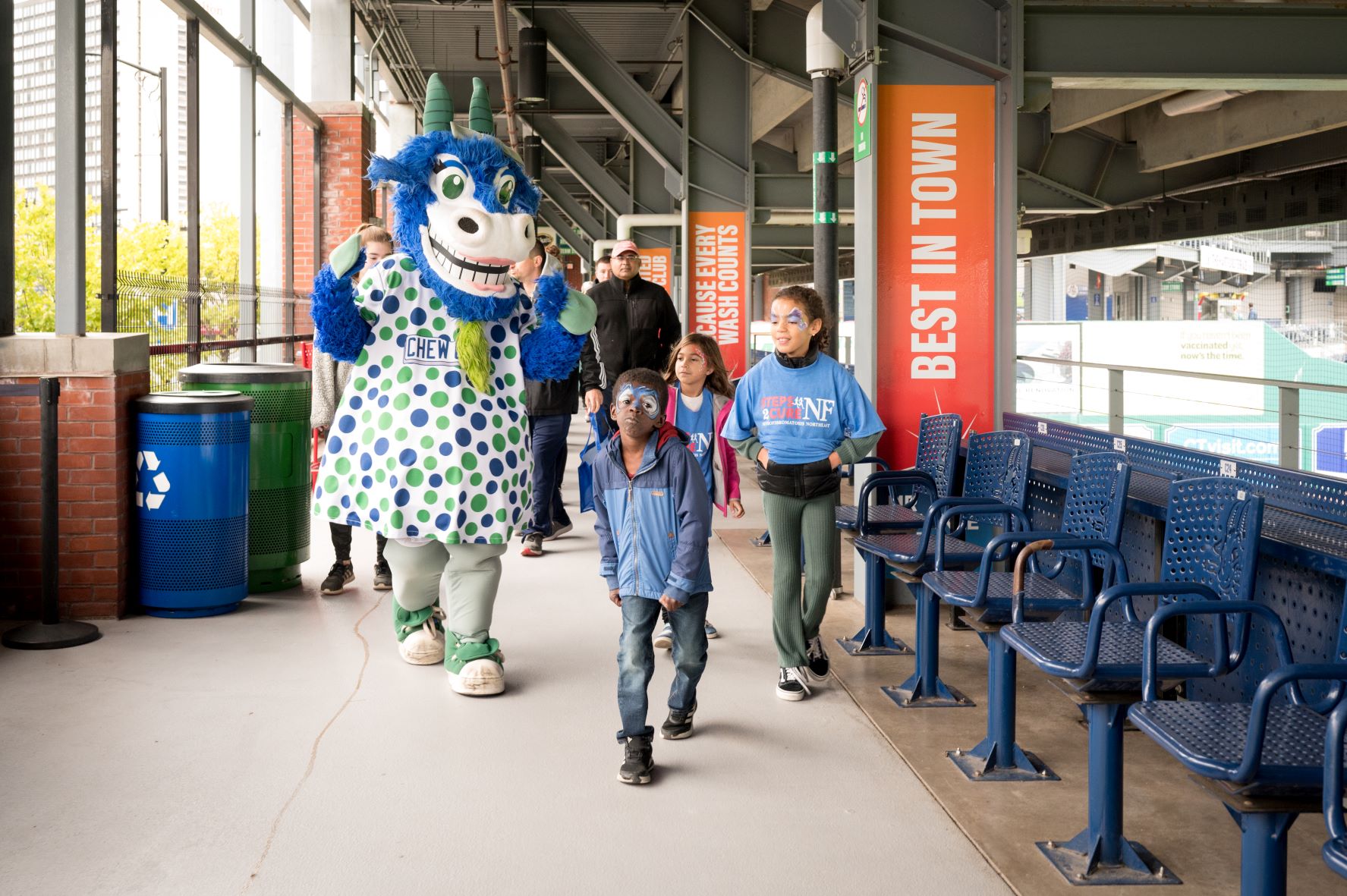 Children walking with Dunkin Donuts Park mascot