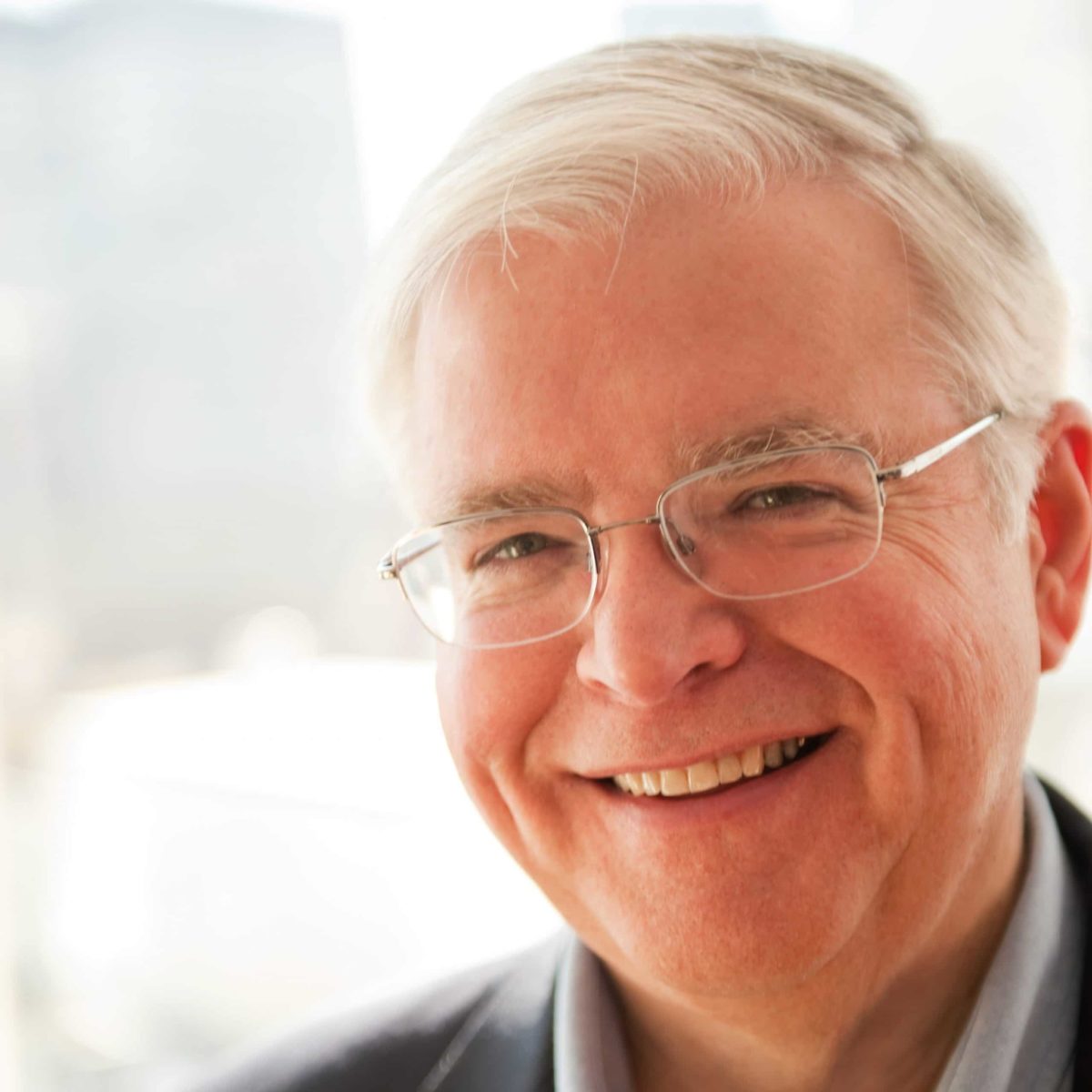 Headshot of a smiling Dr. Jim Gusella with glasses