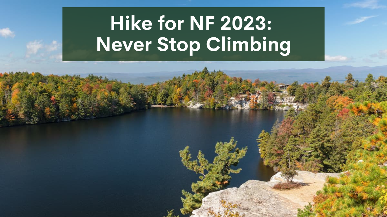 Image of lake surrounded by fall foliage with title "Hike for NF 2023: Never Stop Climbing"