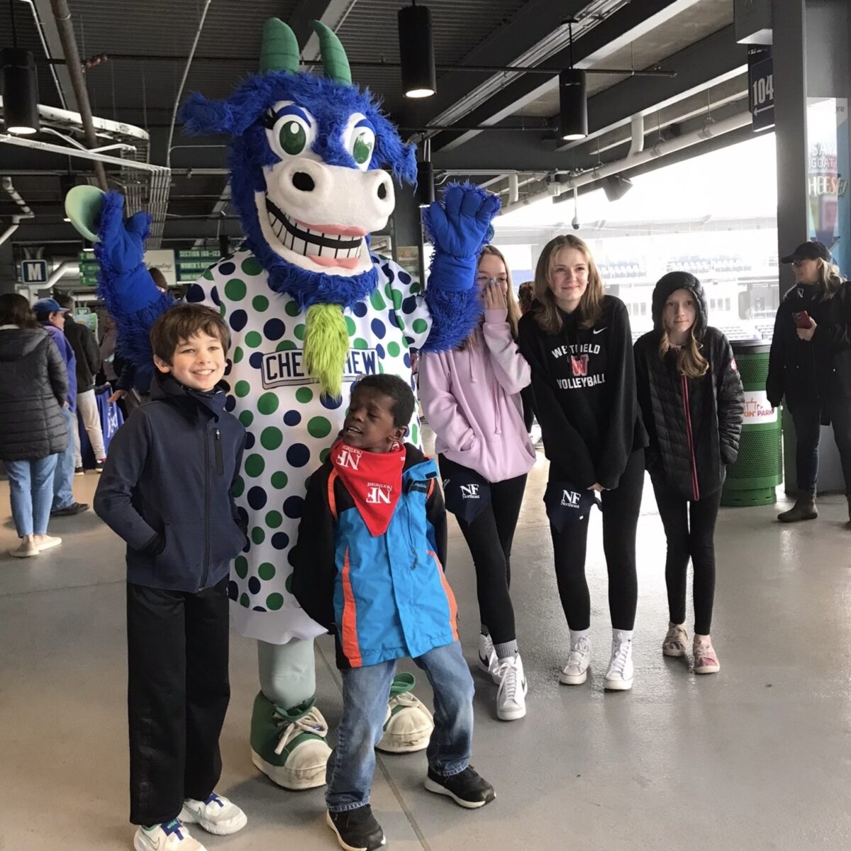 children standing around the Hartford Goats mascot