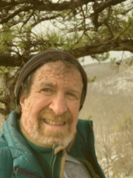 image of man with beard smiling in nature