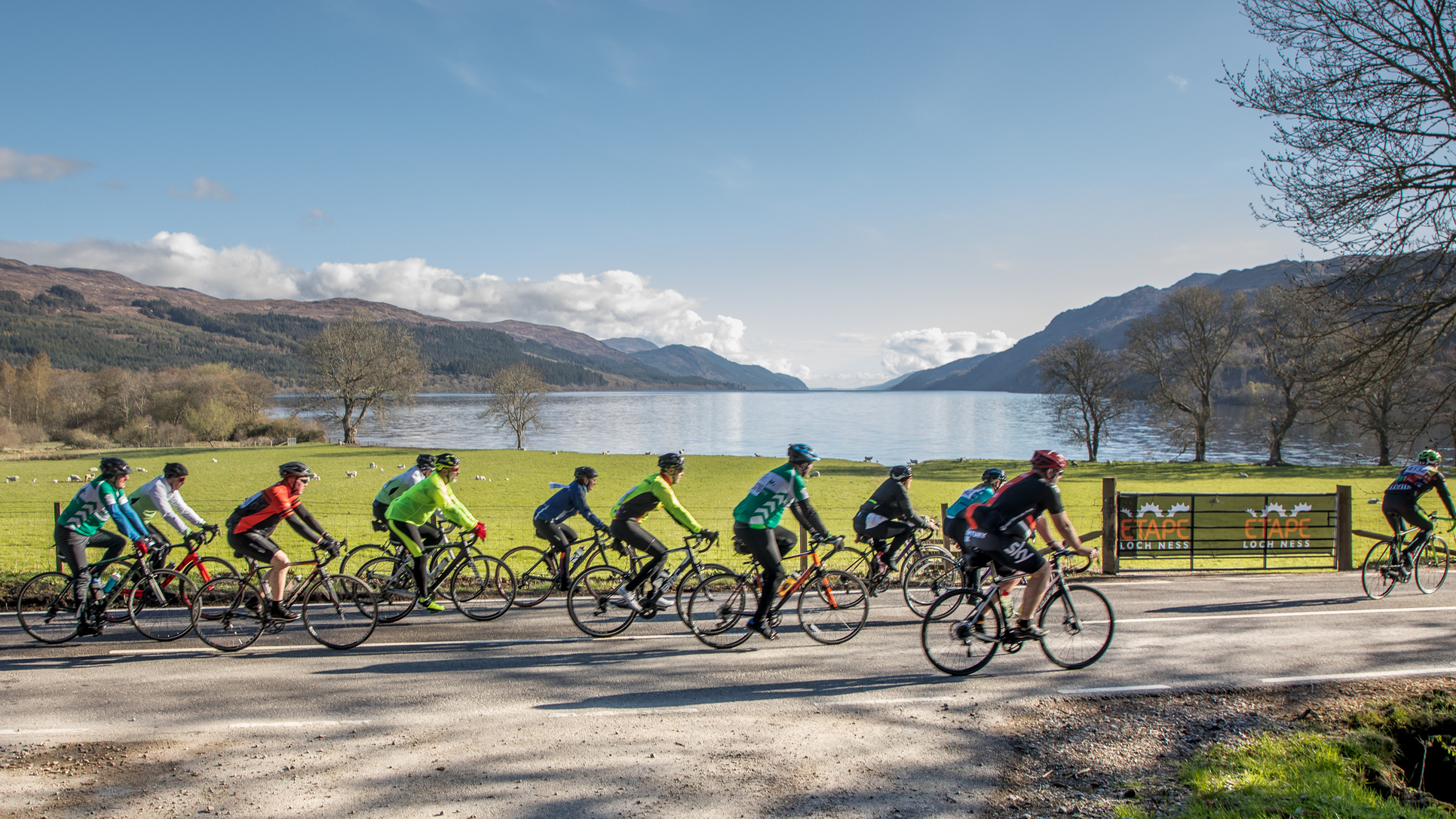 Cyclists riding along the scenic shores of Loch Ness in Scotland during the Etape Loch Ness cycling event.